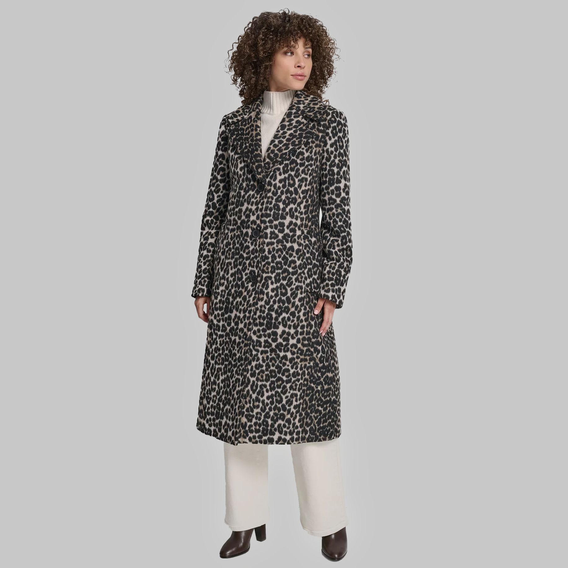 Woman wearing leopard print tailored coat and winter workwear.