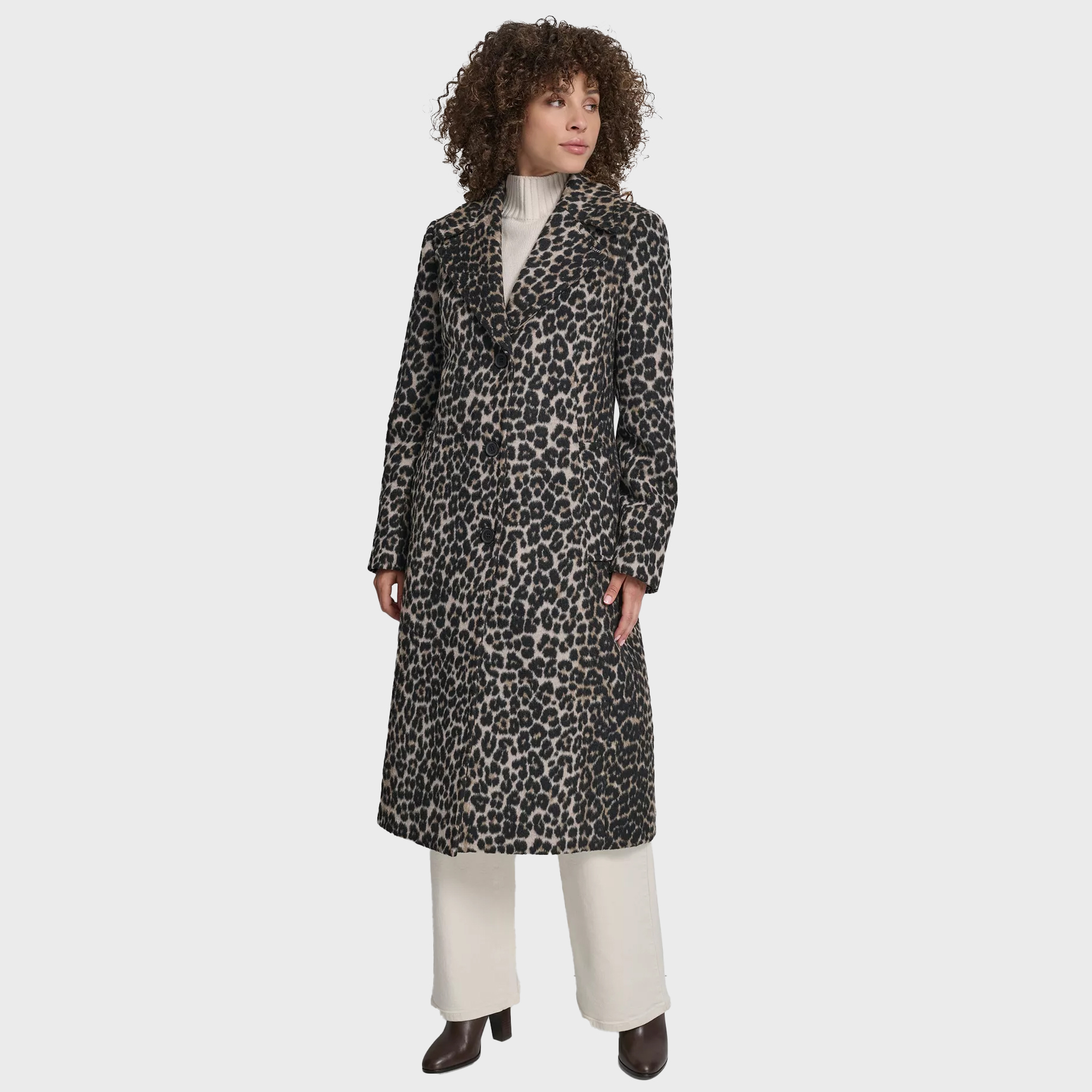 Woman wearing leopard print tailored coat and winter workwear.