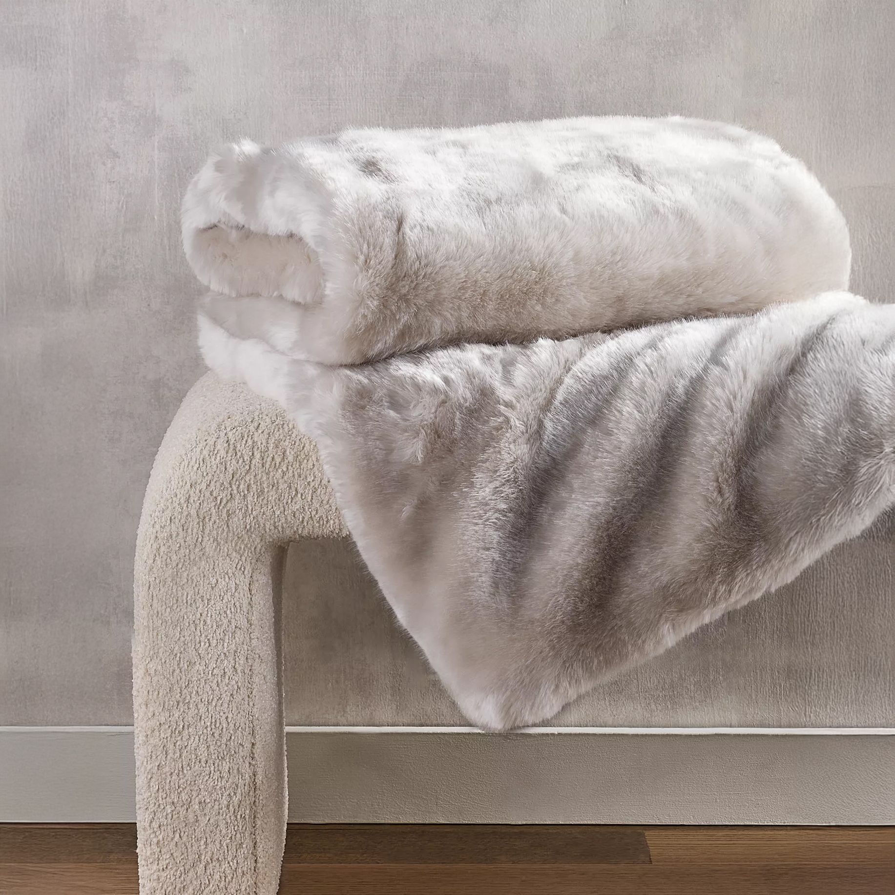 Faux fur throw blanket on boucle bench