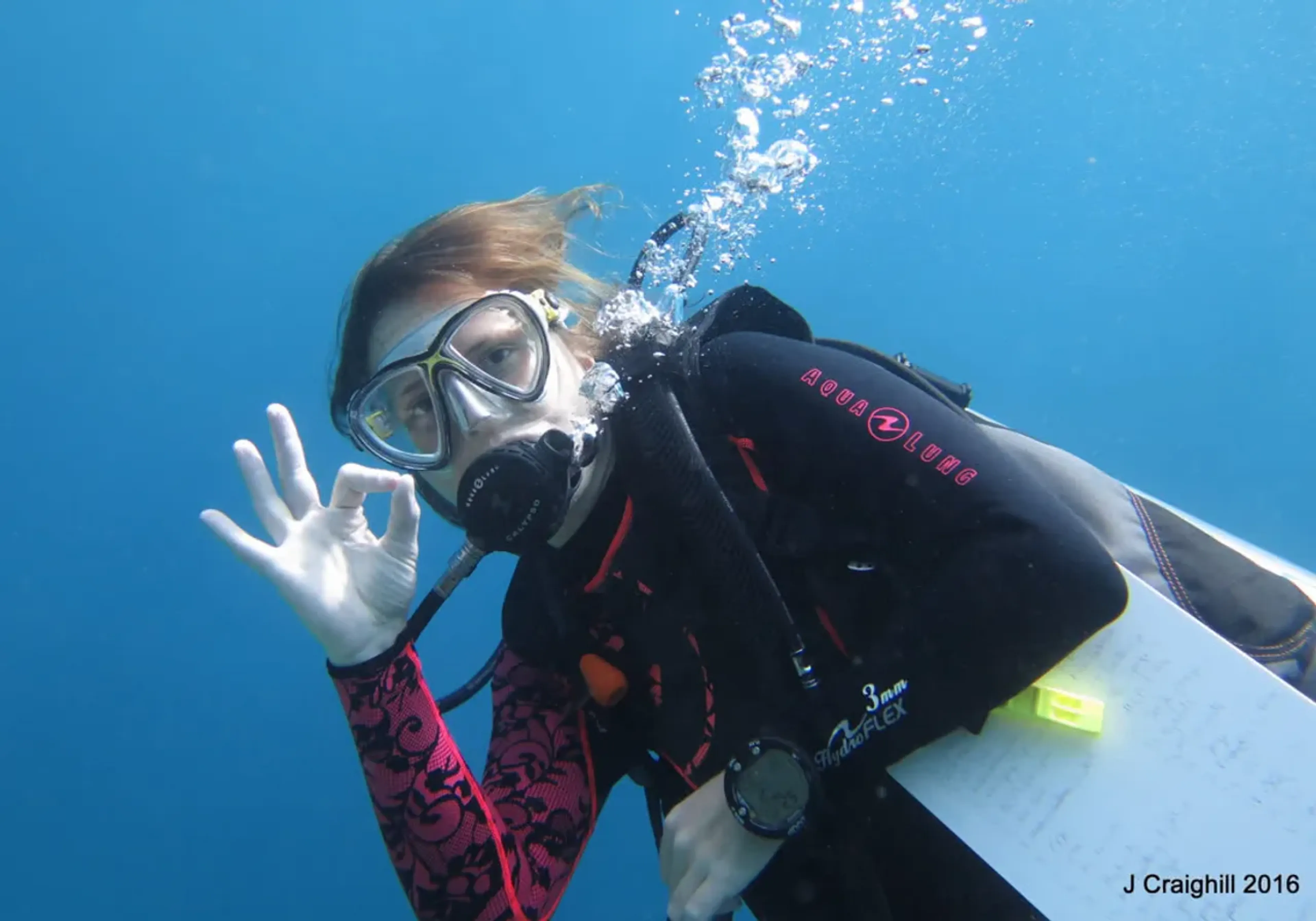 Woman diver with OK sign