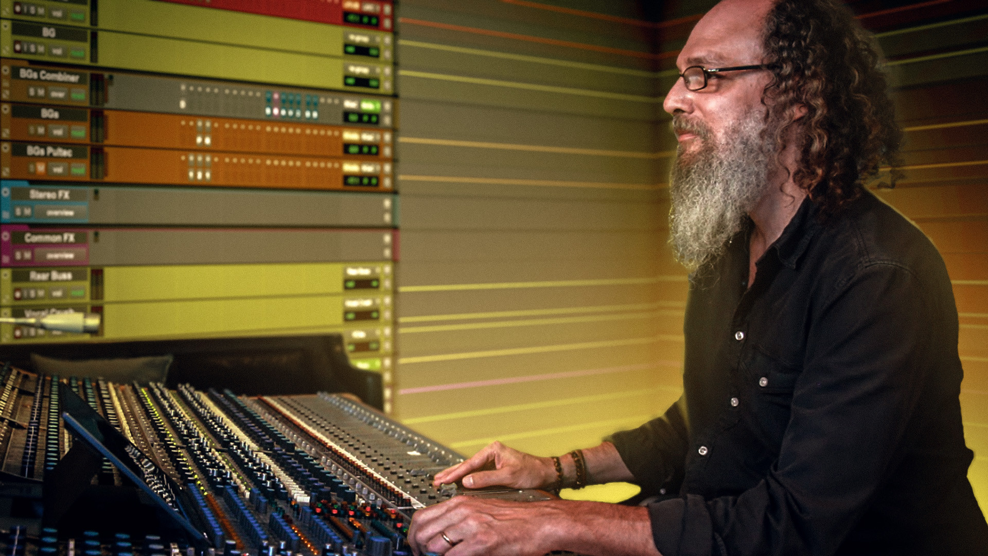 Andrew Scheps 在他的工作室中混音,周围环绕着一个在视觉上与房间融为一体的 Pro Tools 会话,象征着他在 DAW 变成家的状态下独特的混乱与掌控平衡。