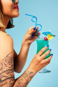 nyc-food-photographer-emily-hawkes-woman-drinking-blue-hawaiian-cocktail.jpeg