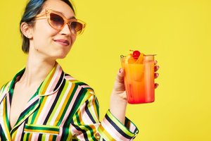 nyc-food-photographer-emily-hawkes-woman-sunglasses-holding-sunrise-cocktail.jpeg