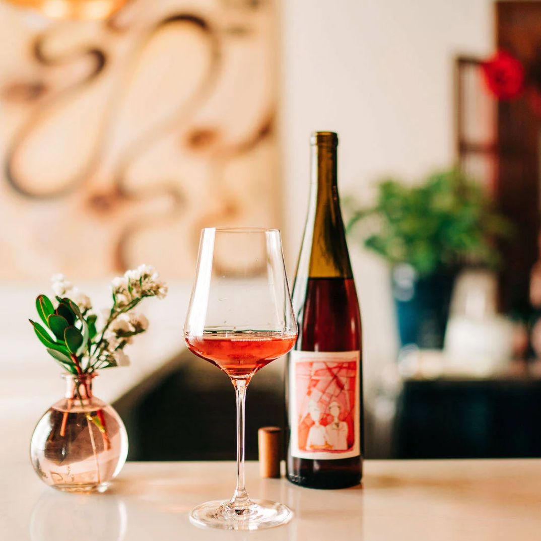Photo of a bottle and a glass of wine at Alma