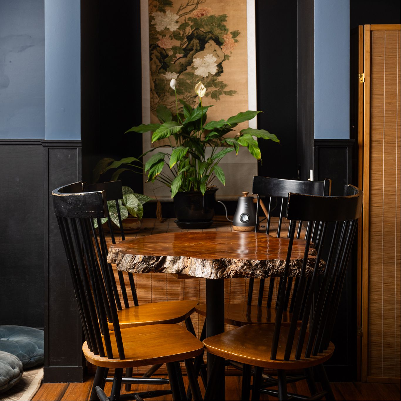 Photo of the interior space of Blue Willow Tea. Tables for four that can be booked via reservations.