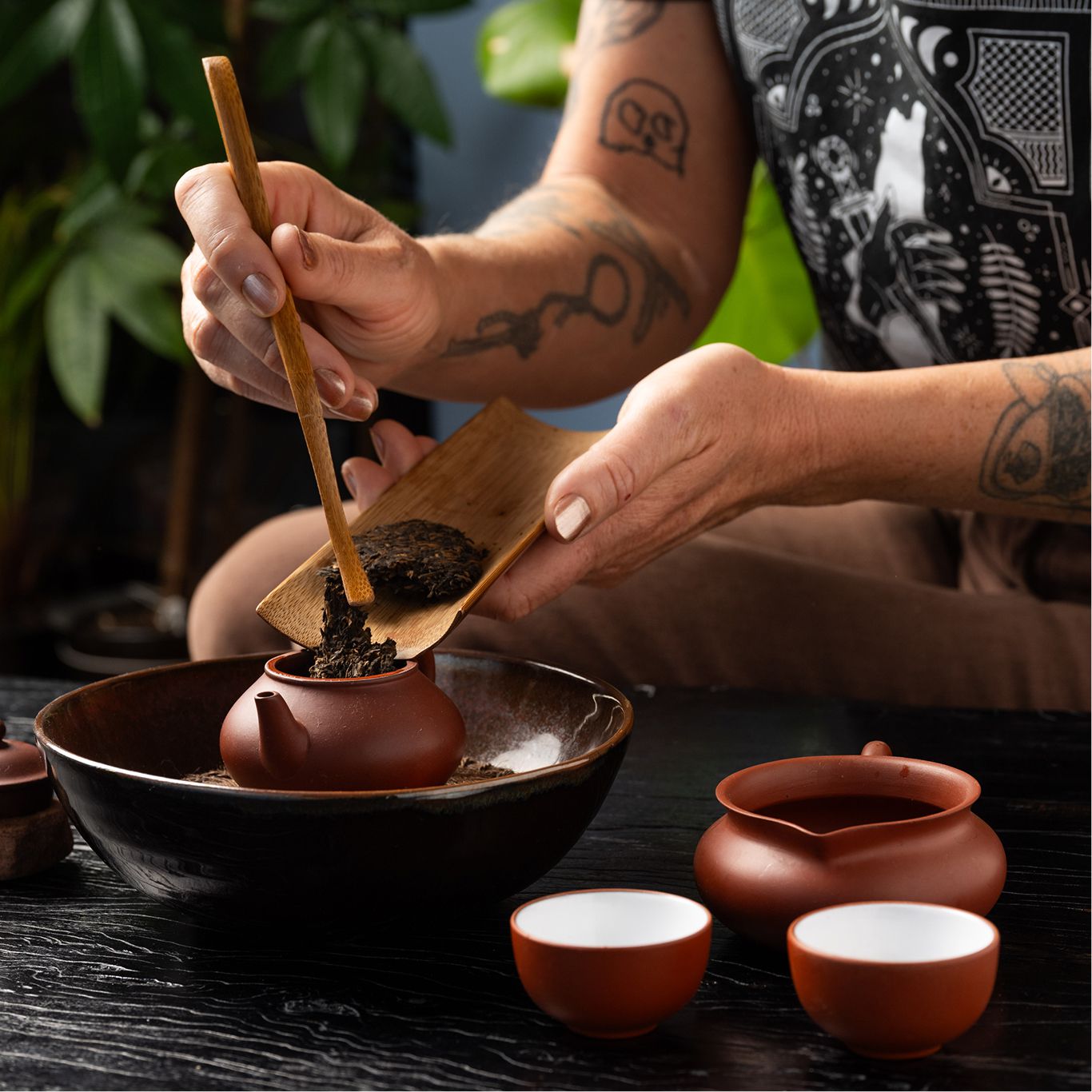 Photo of Founder and Owner, Ali Roth, preparing tea in a tea ceremony.