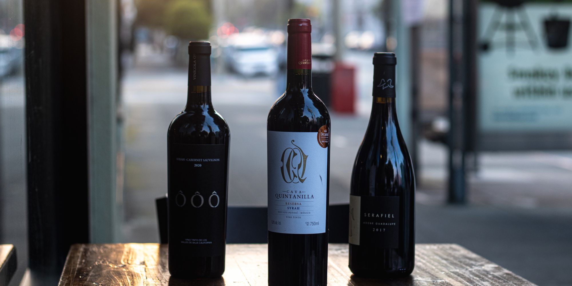 Photo of three bottles of Mexican wines on a table in Cantina Los Mayas