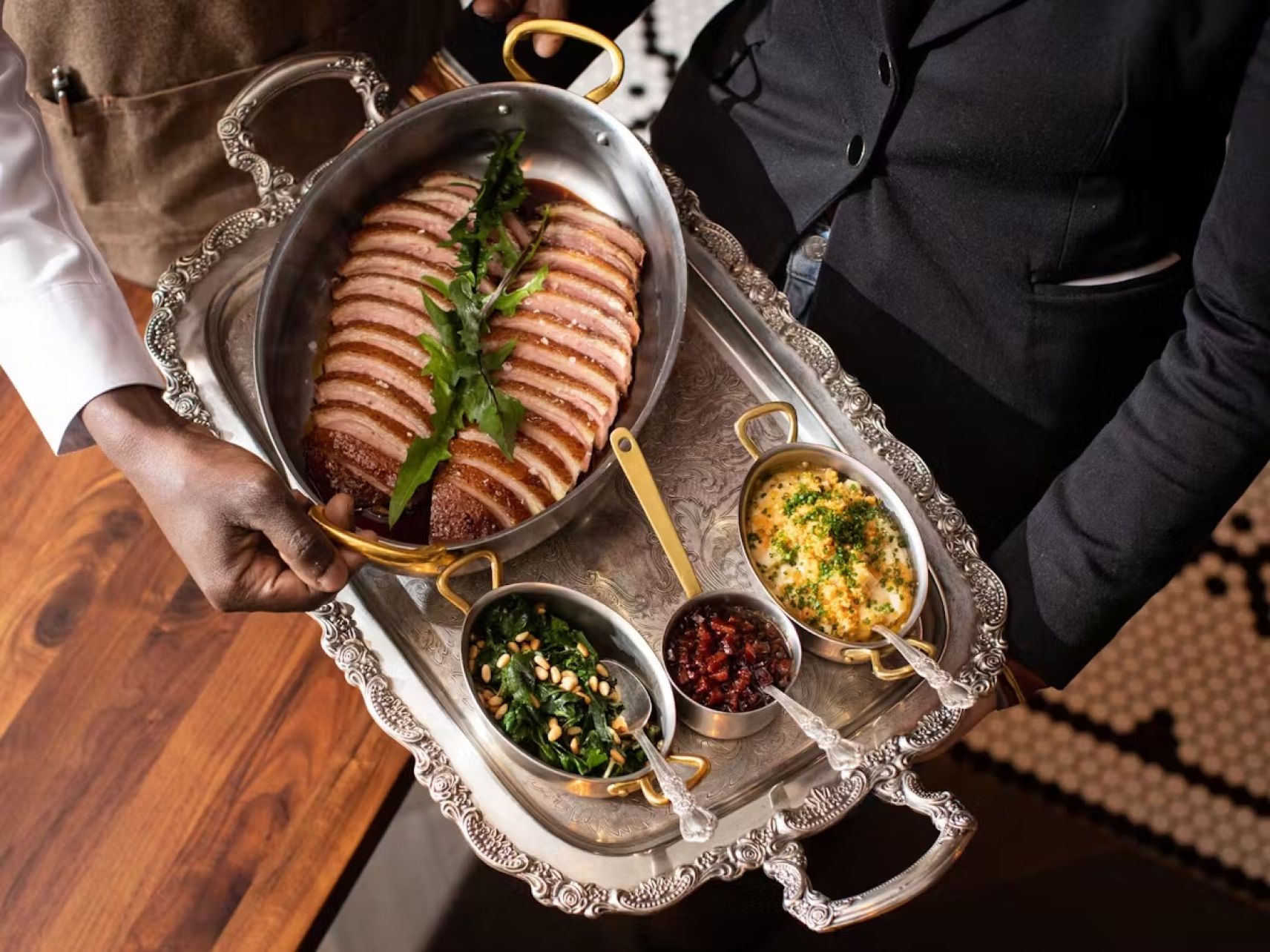 Photo of duck being served at Francie with various sides