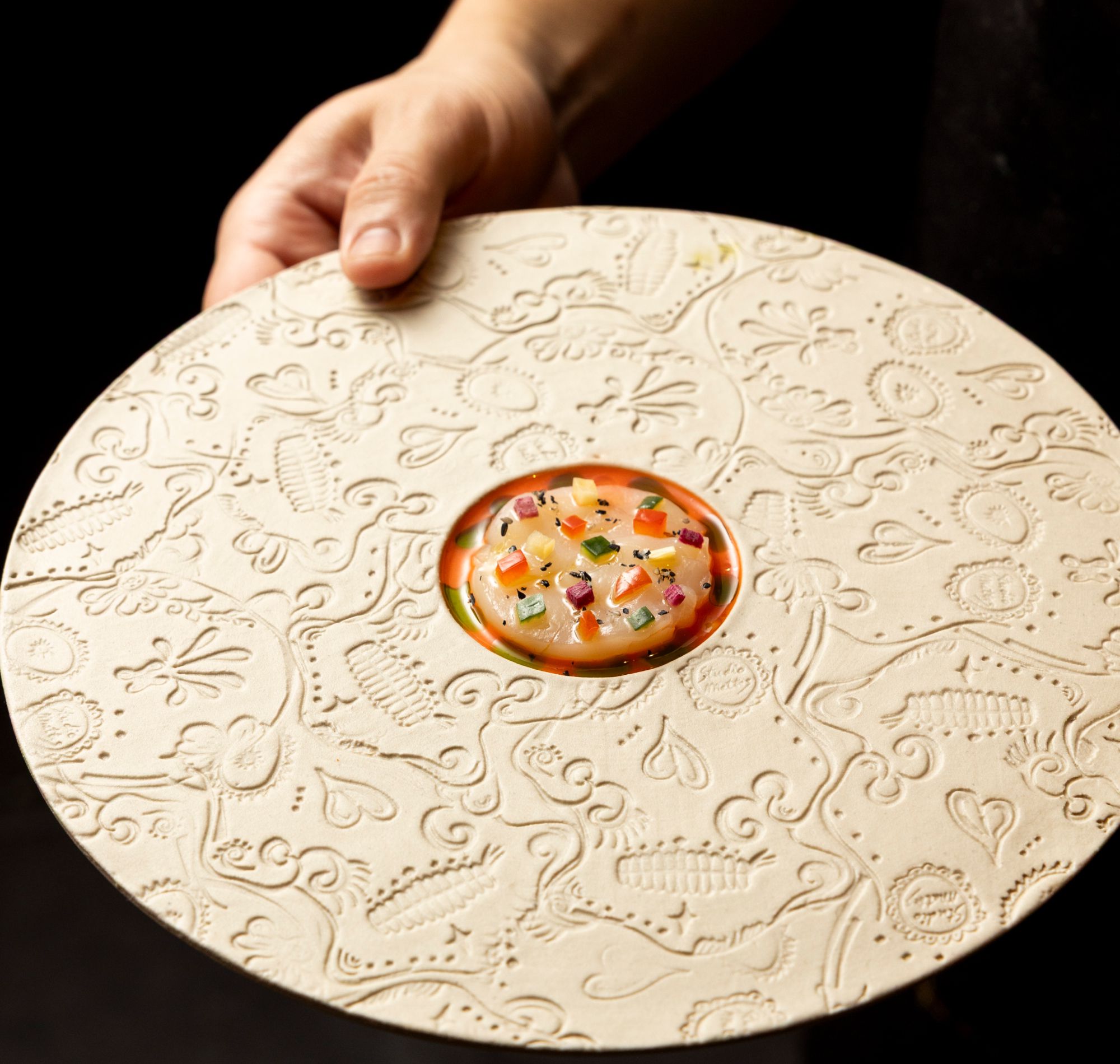 A dish being presented at MINŌ