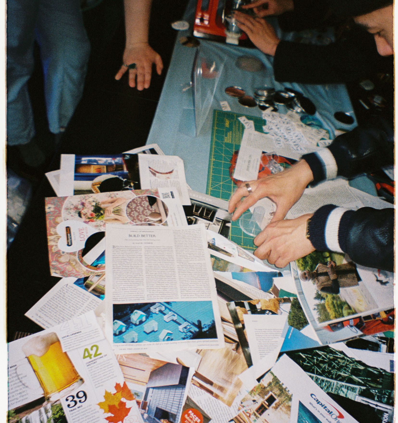 Photo of people arranging a collage of postcards