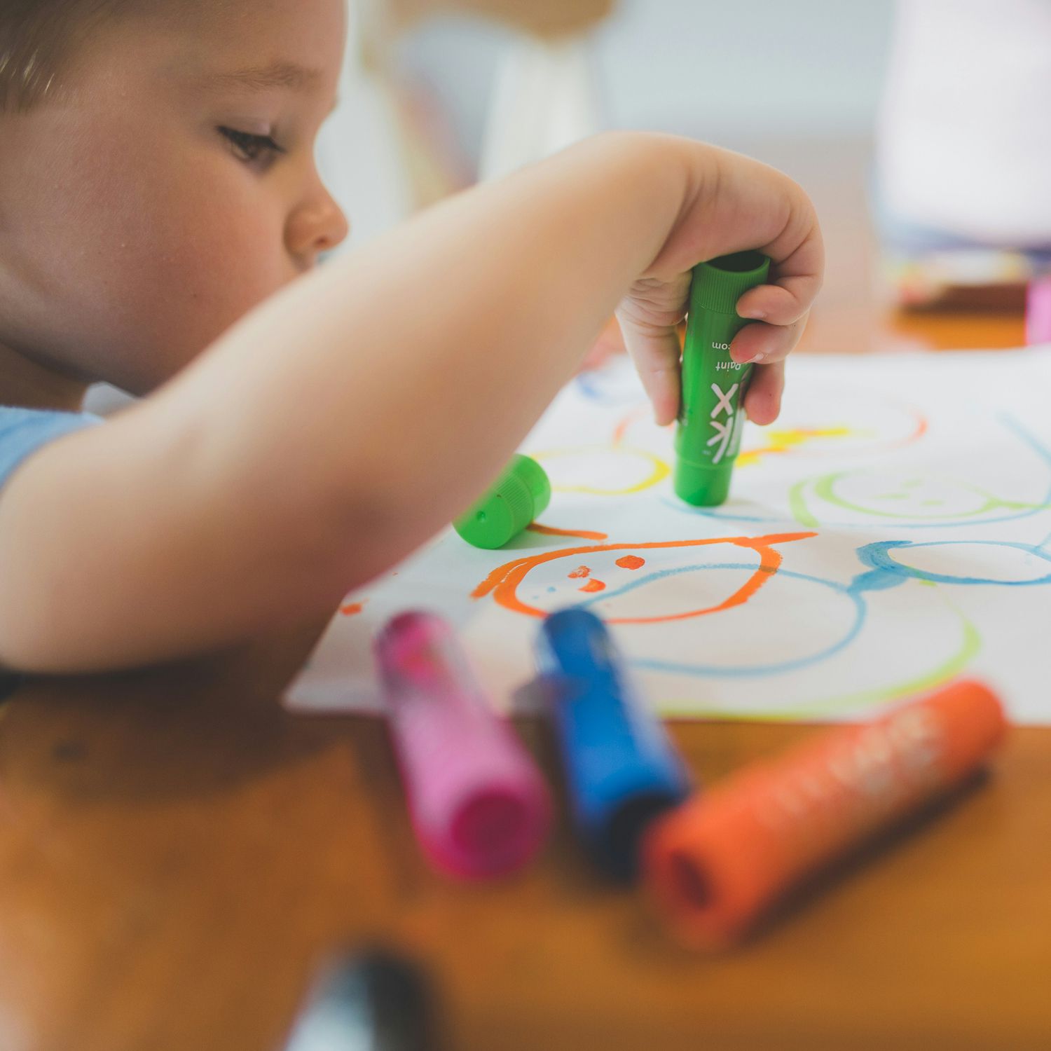 Child using paint sticks
