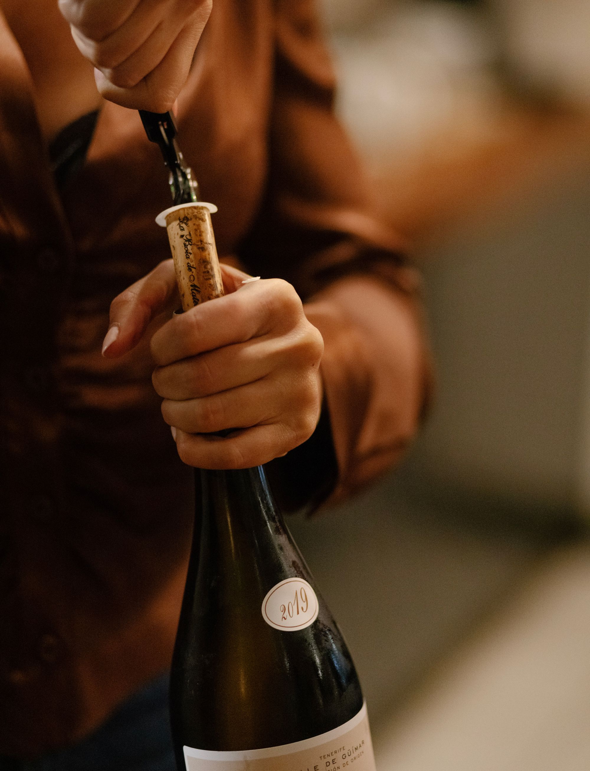 Photo of a bottle of wine being uncorked at Stationæry