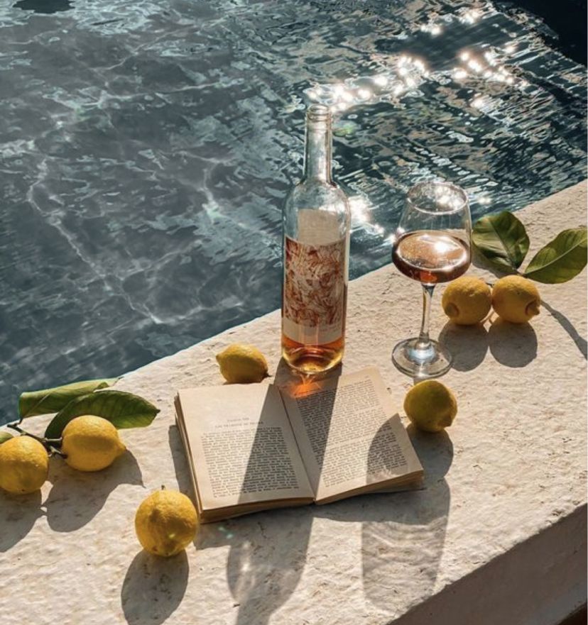 Photo of drinks and a book by the pool