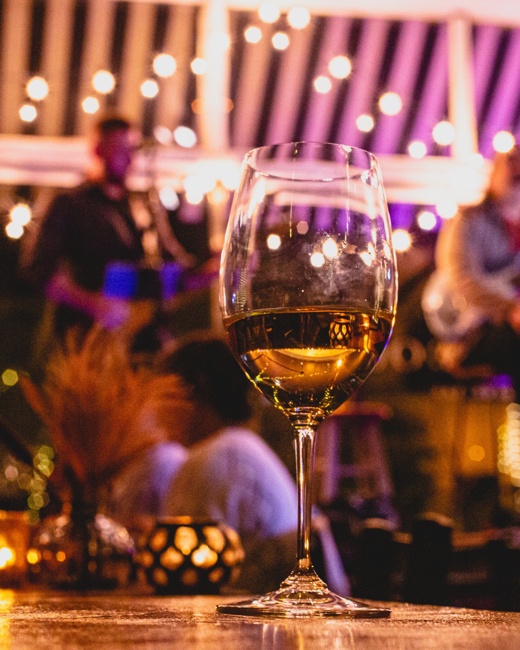 Photo of wine glass in interior of Troubadour in the evening