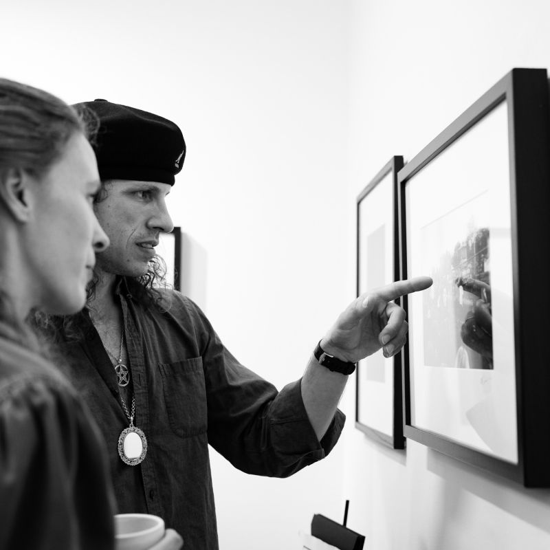 Two Wynter Gallery patrons viewing and discussing a photographic work on exhibit