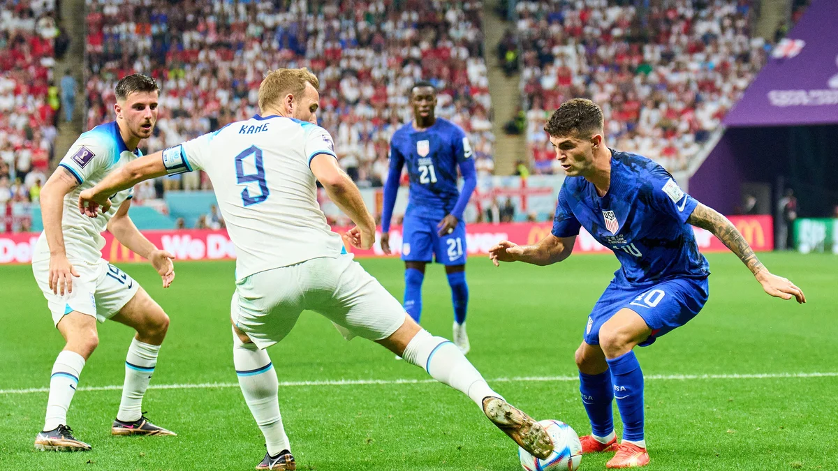 England's Harry Kane (9) and USA's Christian Pulisic (10) challenge for the ball during their 2022 World Cup match.