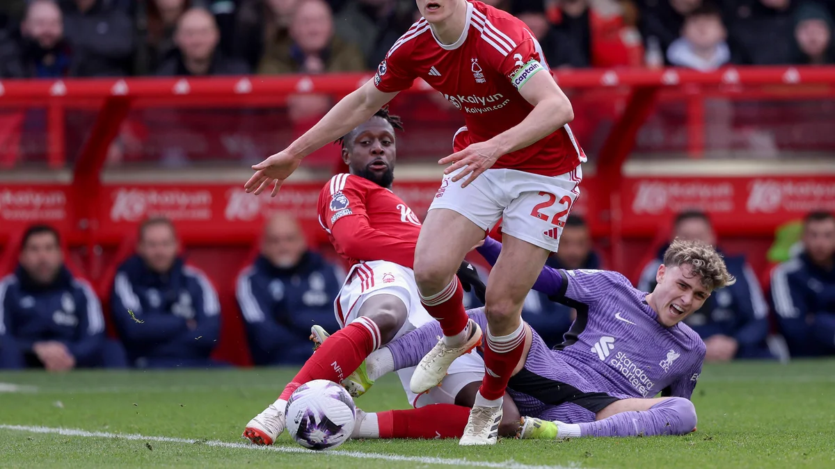 Divock Origi of Nottingham Forest tackles Bobby Clark of Liverpool during a Premier League match.