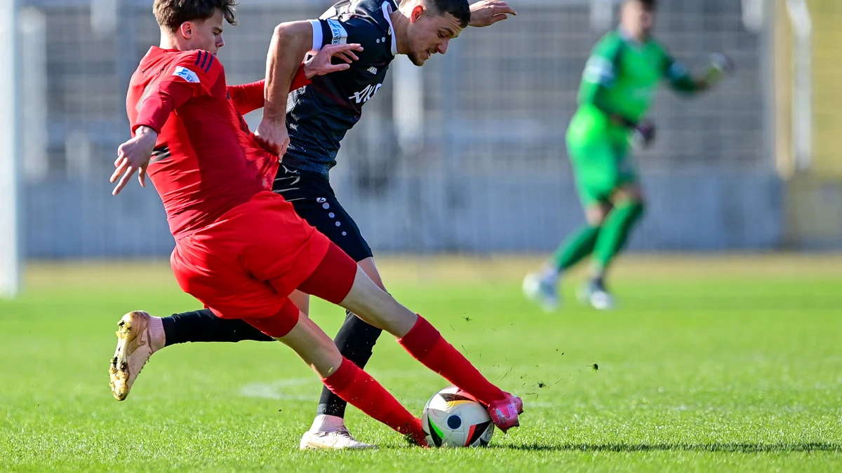 Jonathan Asp Jensen (left) of Bayern Munich II tackles Maximilian Zaiser of Würzburger Kickers.