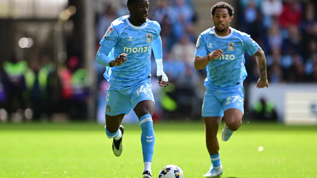 Romain Esse (14) of Coventry City sprints with the ball, supported by teammate Milan Van Ewijk (27) during a match.