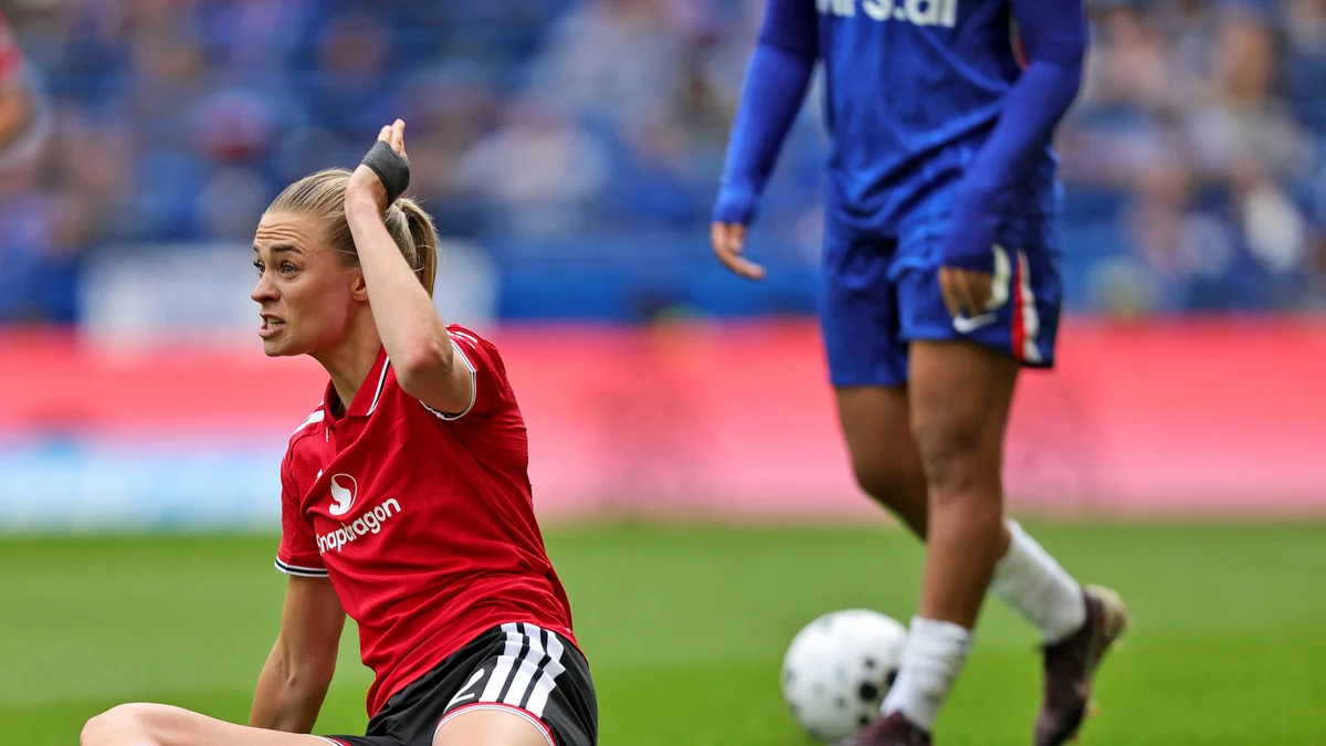 Manchester United's Fridolina Rolfö reacts with frustration after a foul during a match.