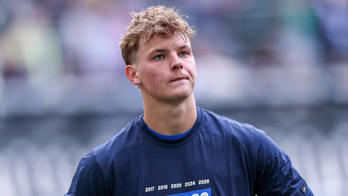 Cole Campbell, wearing TSG Hoffenheim's number 20 jersey, stands with his teammates looking dejected after a 0-4 loss.