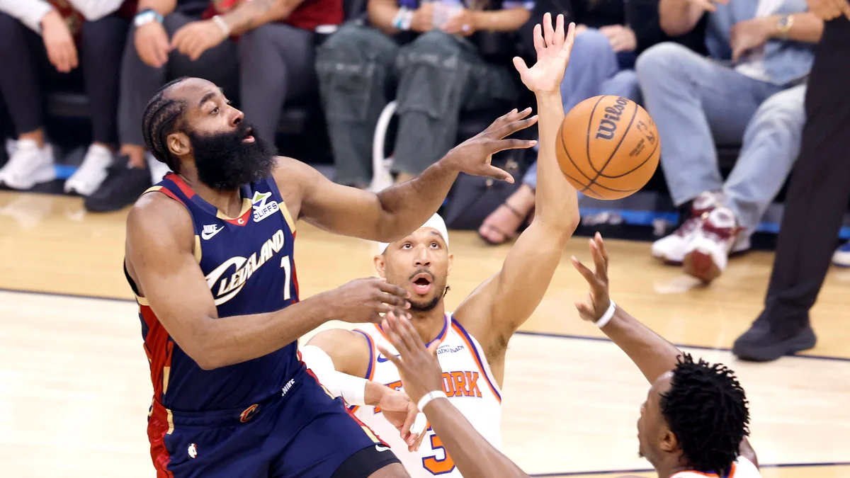 James Harden of the Cavaliers passes the ball while guarded by two Knicks players during an Eastern Conference Final game.