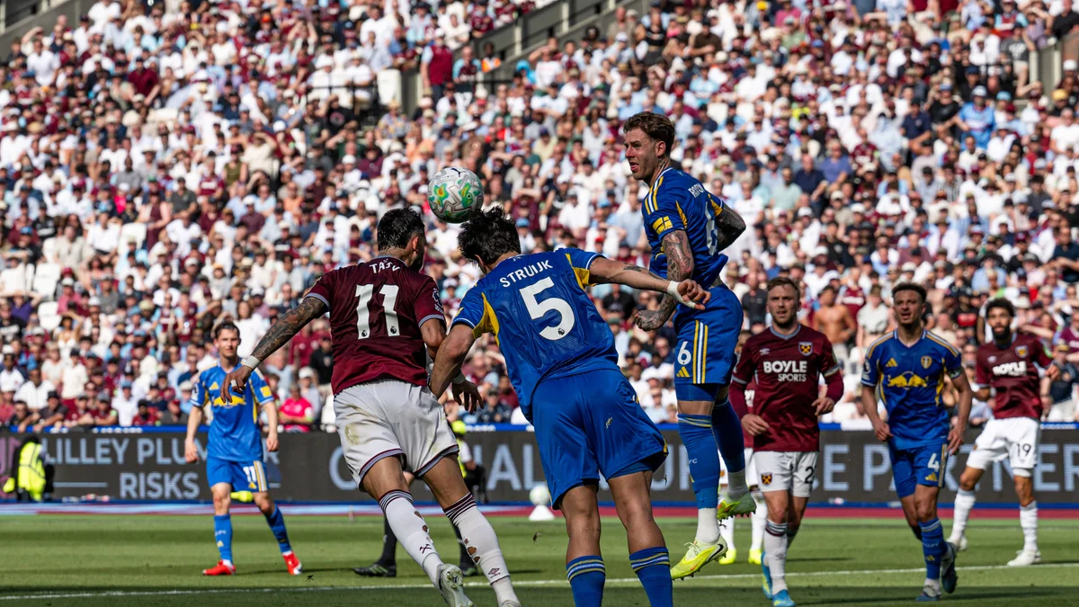 Pascal Struijk of Leeds United heads the ball defensively against West Ham's Taty Castellanos.