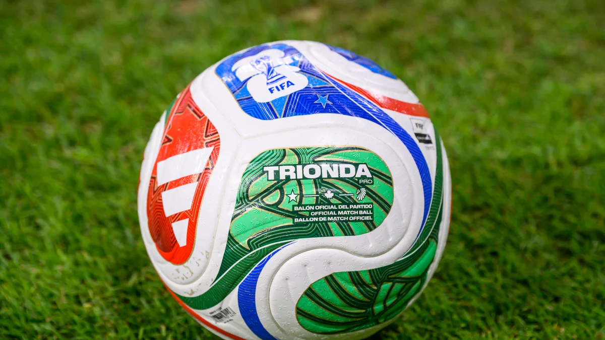 Close-up of the official FIFA World Cup 2026 match ball, 'Trionda', on the pitch during Qatar's training.