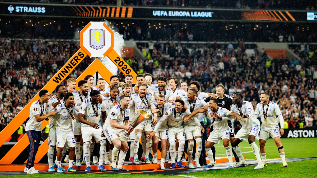 Aston Villa players celebrate with the UEFA Europa League trophy after winning the 2026 final against SC Freiburg.