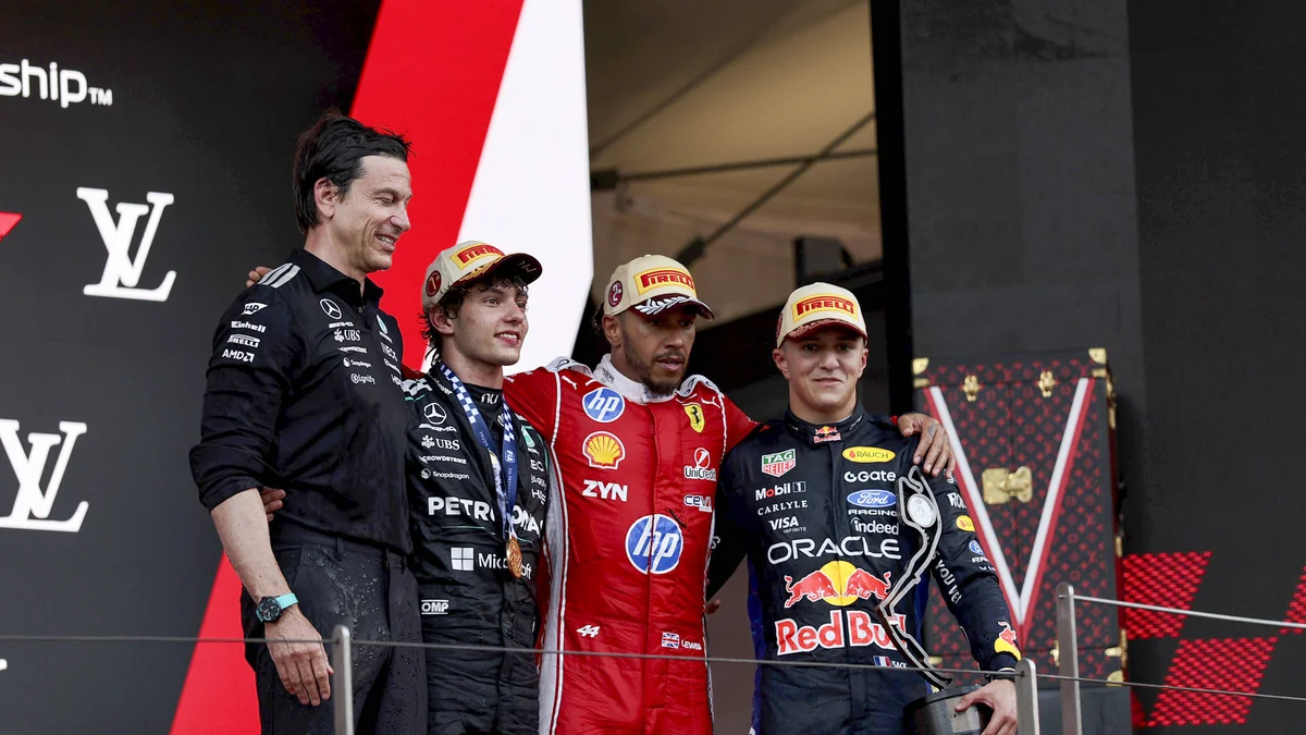 Winner Andrea Kimi Antonelli, Lewis Hamilton, Isack Hadjar, and Toto Wolff celebrate on the Monaco Grand Prix podium.