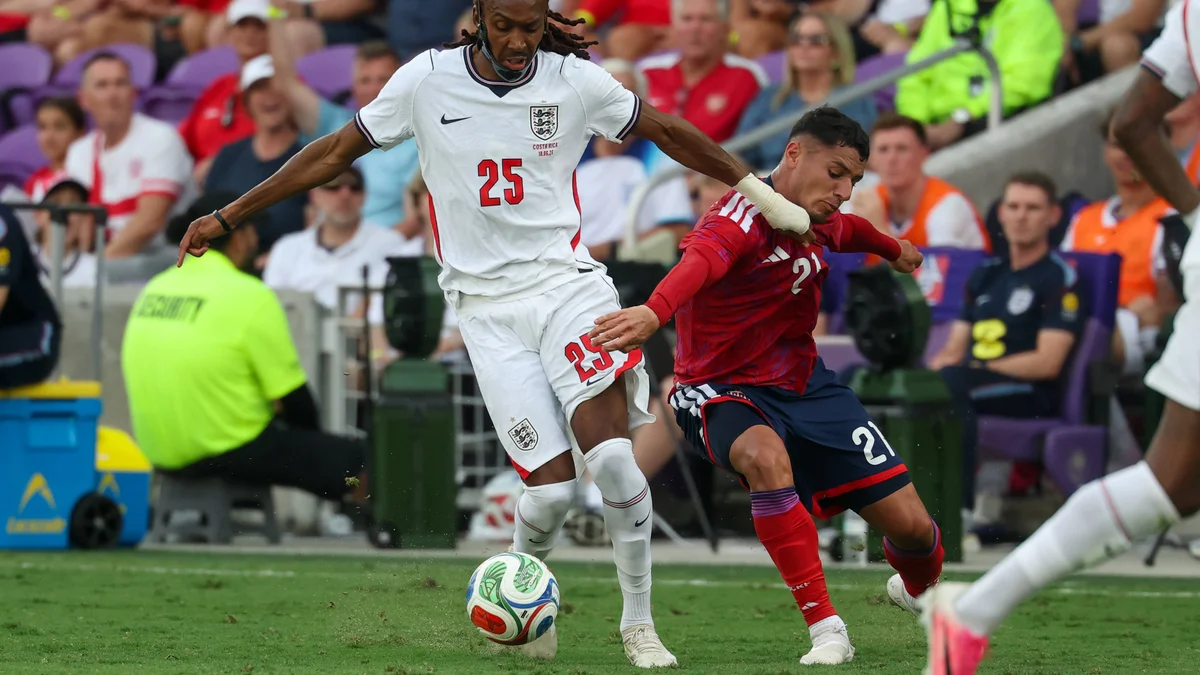 England's Djed Spence, in white, dribbles past Costa Rica's Doryan Rodriguez Soto during a friendly match.