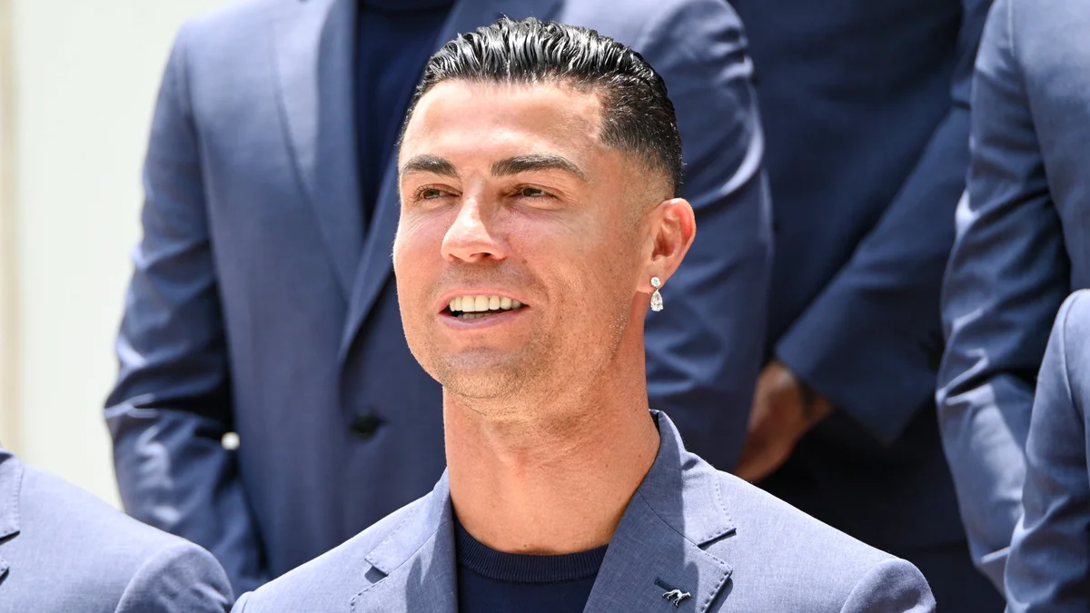 Close-up portrait of Portugal captain Cristiano Ronaldo, smiling confidently at an official reception before the 2026 World Cup.