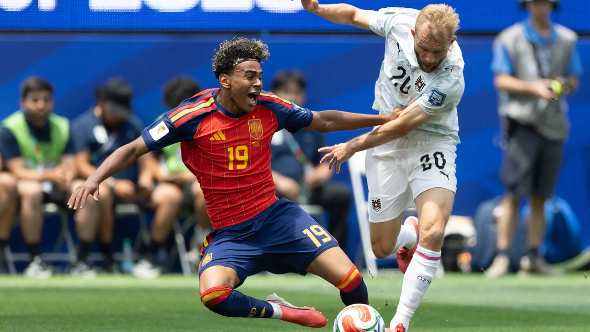 Spain's Lamine Yamal (19) and Austria's Konrad Laimer (20) challenge for the ball during a World Cup match.
