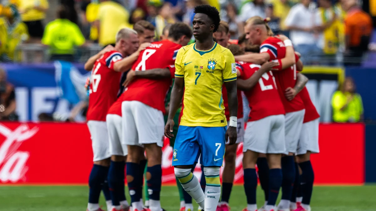 Vinicius Junior, in a yellow Brazil jersey, dribbles the ball during a FIFA World Cup match.