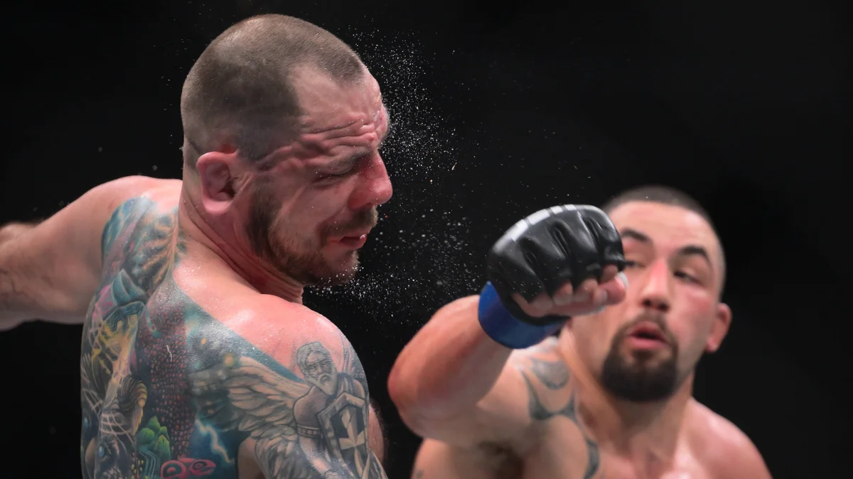 Robert Whittaker celebrates his TKO victory over Nikita Krylov at UFC 329 in Las Vegas.