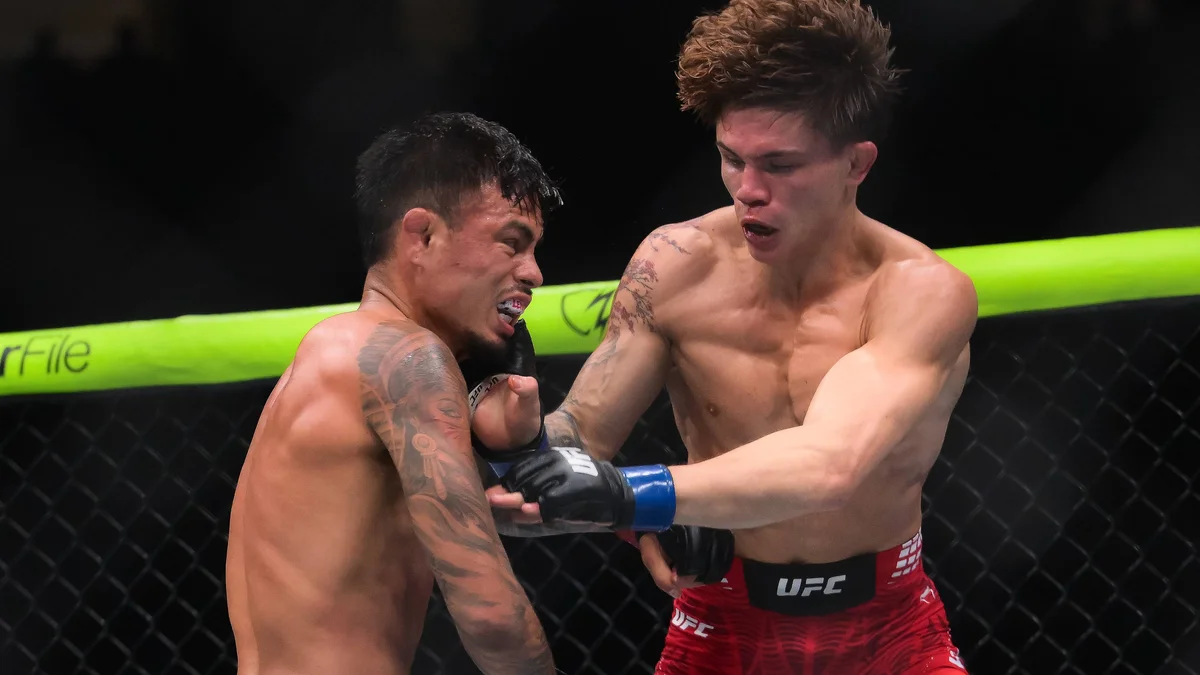 Brandon Royval applies a rear-naked choke to Lone'er Kavanagh during their UFC 329 fight.