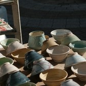 Handmade ceramics displayed outdoors at a craft fair