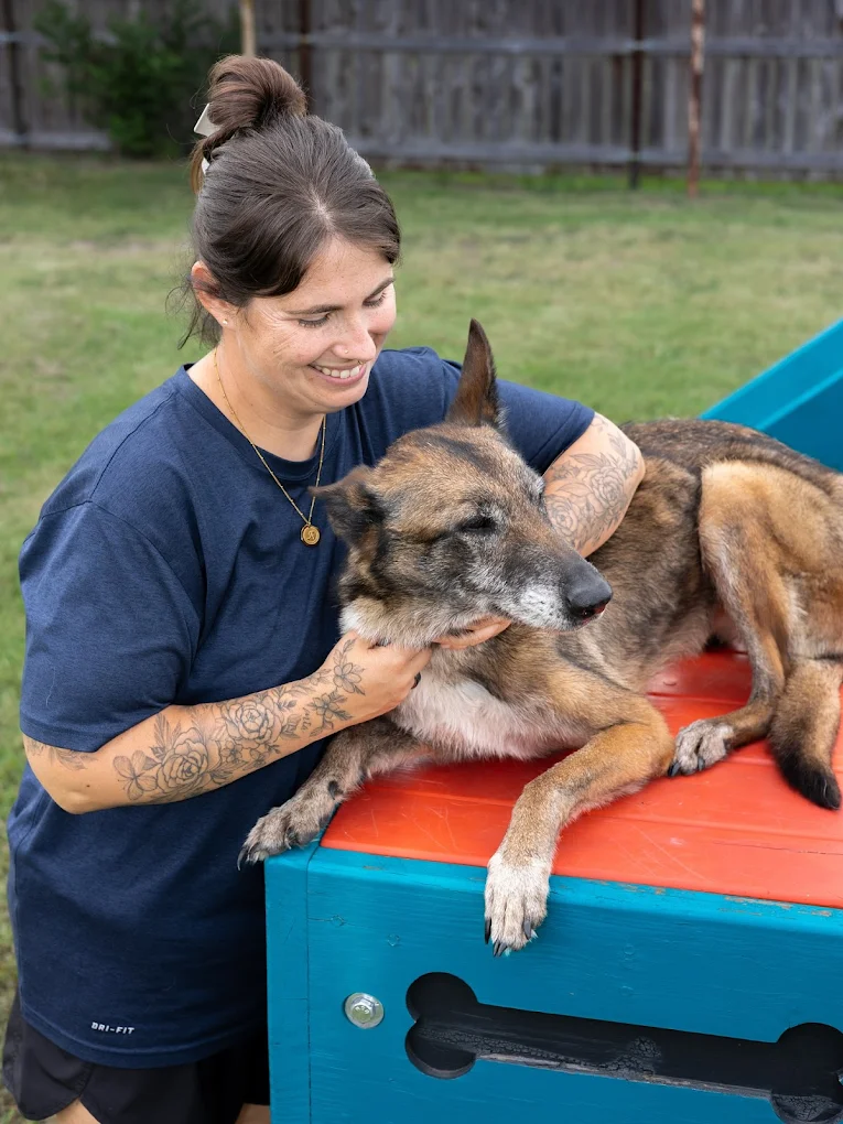 Ashley, co-owner of ATX K9 Dog Training, with a dog