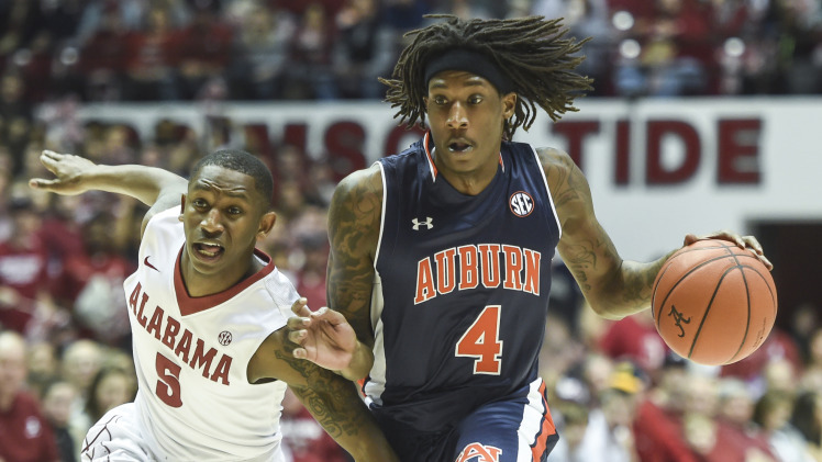 Auburn's T.J. Dunans rushes past Justin Coleman and Alabama