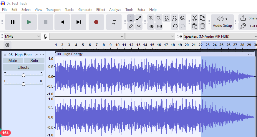 An audio clip selected in Audacity with a visible fade-out applied using the Effect menu, showing gradual volume decrease.