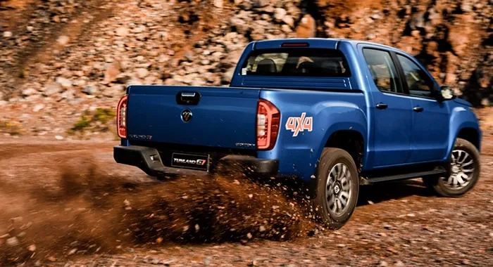 Foton G7 4x4 azul. Pickup todoterreno en acción, levantando tierra.