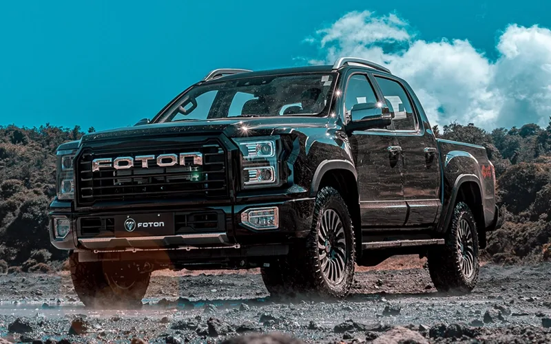 Foton G9 negra, camioneta pickup 4x4 imponente en terreno off-road.