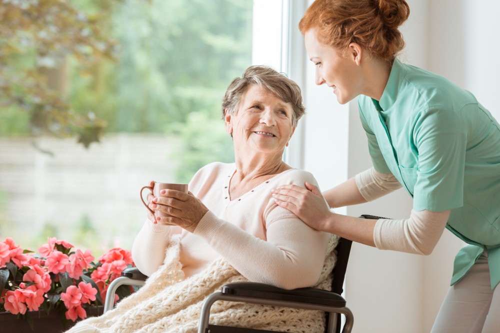Caregiver comforting senior living resident