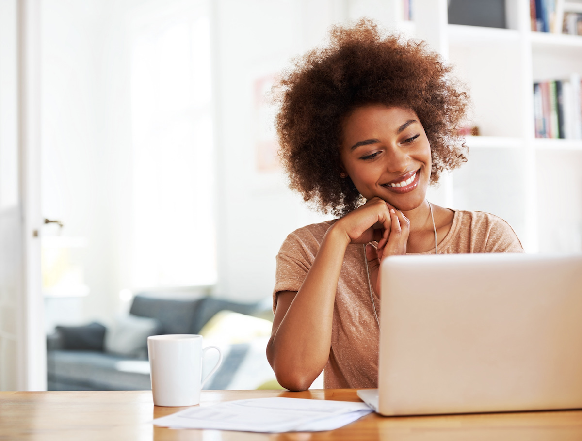 Woman looking thoroughly pleased with her work-from-Anywhere proposal