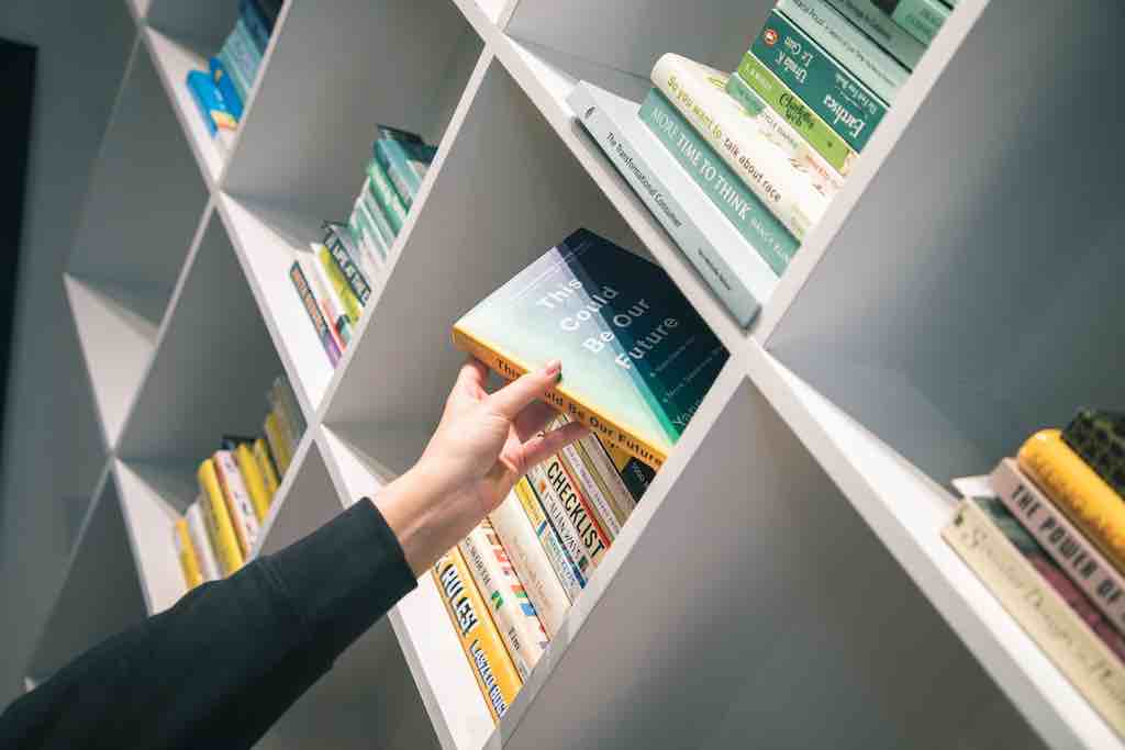 Pulling a book from your massive bookshelf in your home office