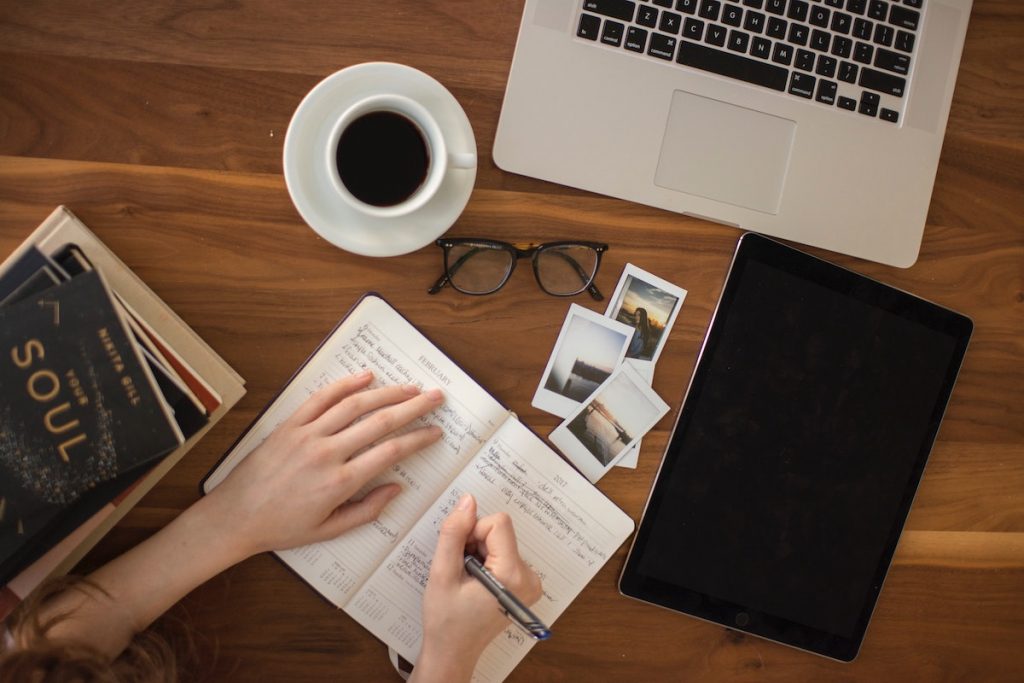 Man writing IT security plan to work from home