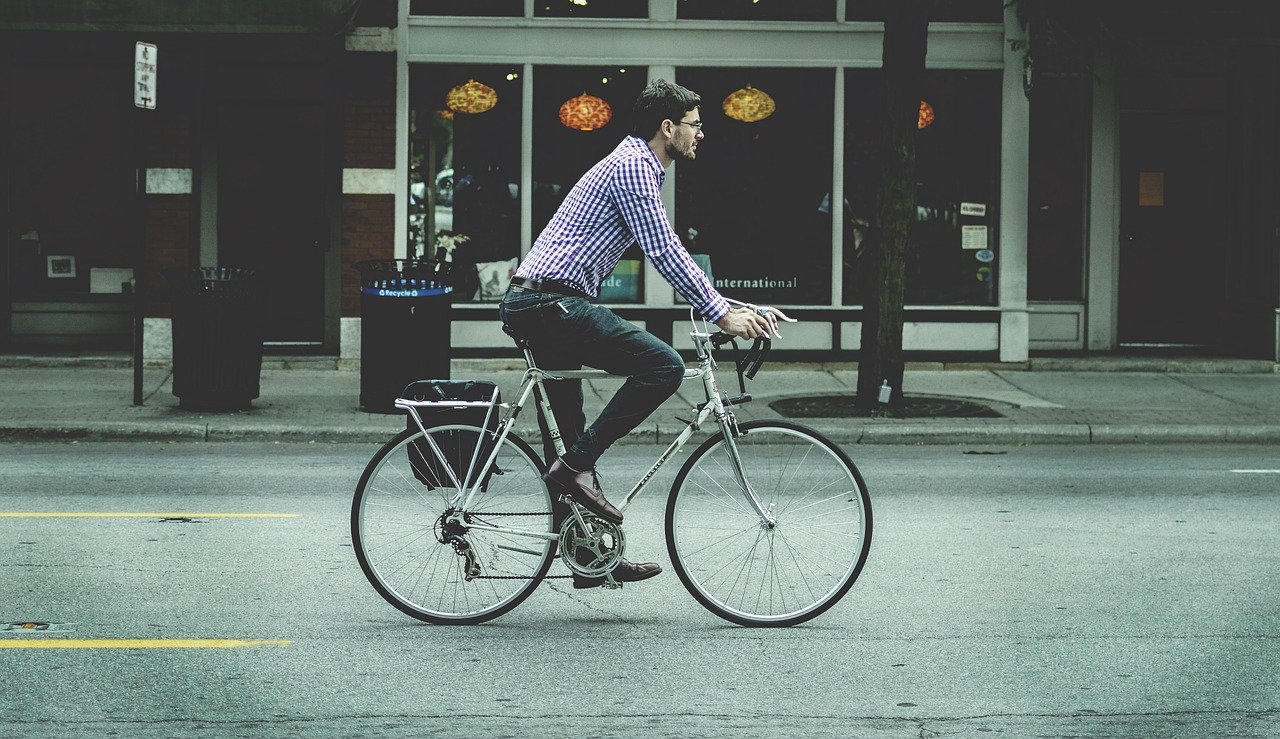 Man active commuting to the office on bicycle