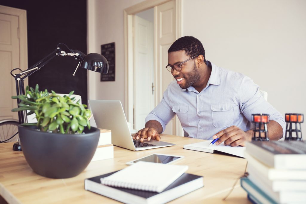 Man at home office preparing to work from home as part of his morning routine