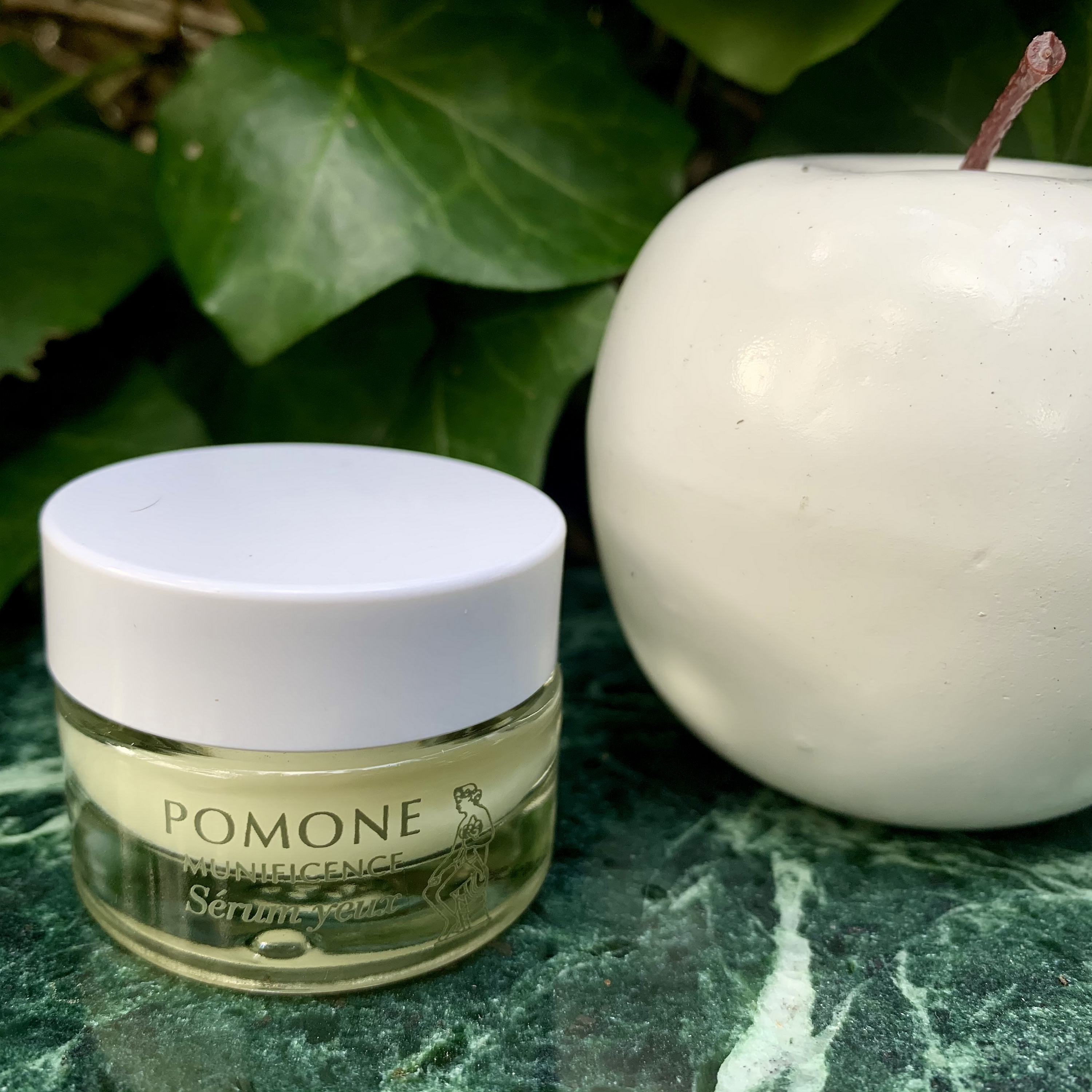 EYE SERUM with a white apple