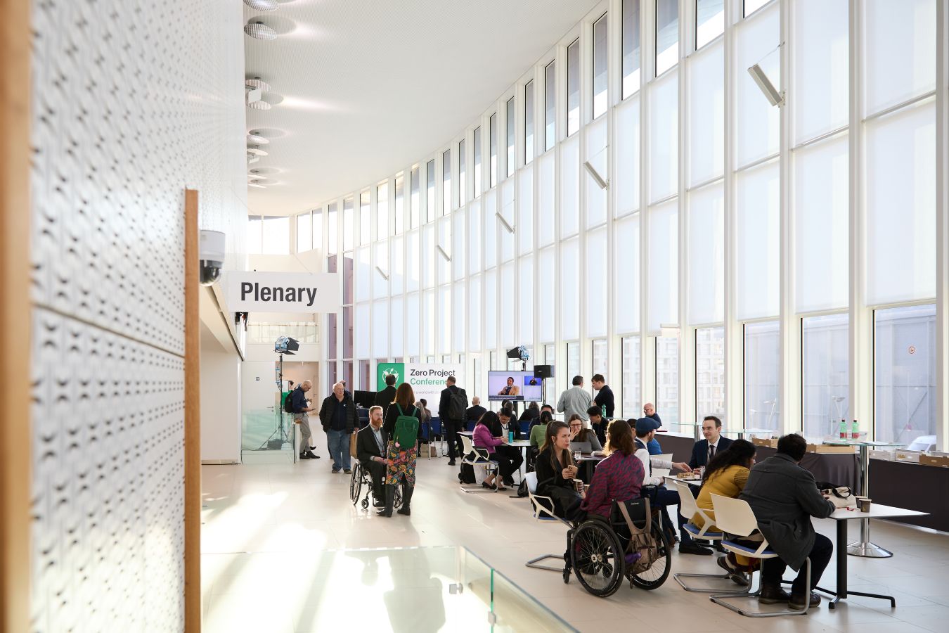 A photo showing conference participants inside the M-Building, next to the plenary rooms